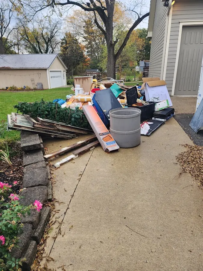 Dumpster being loaded with debris for Estate Cleanout Dumpster Rental in Irving